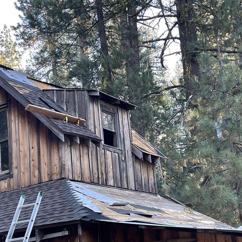 Asphalt shingle roof removal and installation on cabin