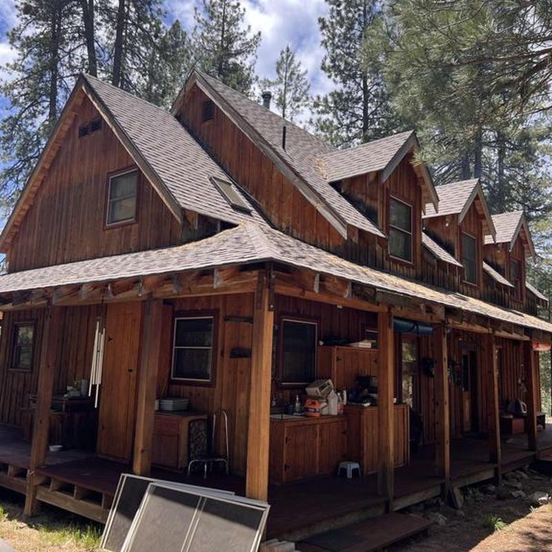 GAF asphalt shingle roof on cabin in meadow