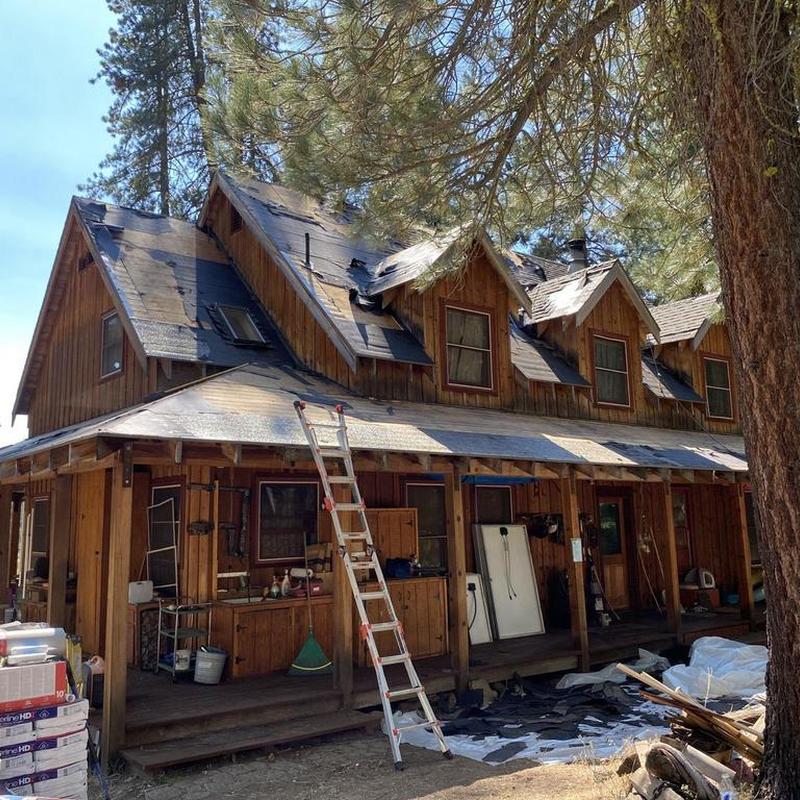 Asphalt shingle roof stripping on wooden cabin