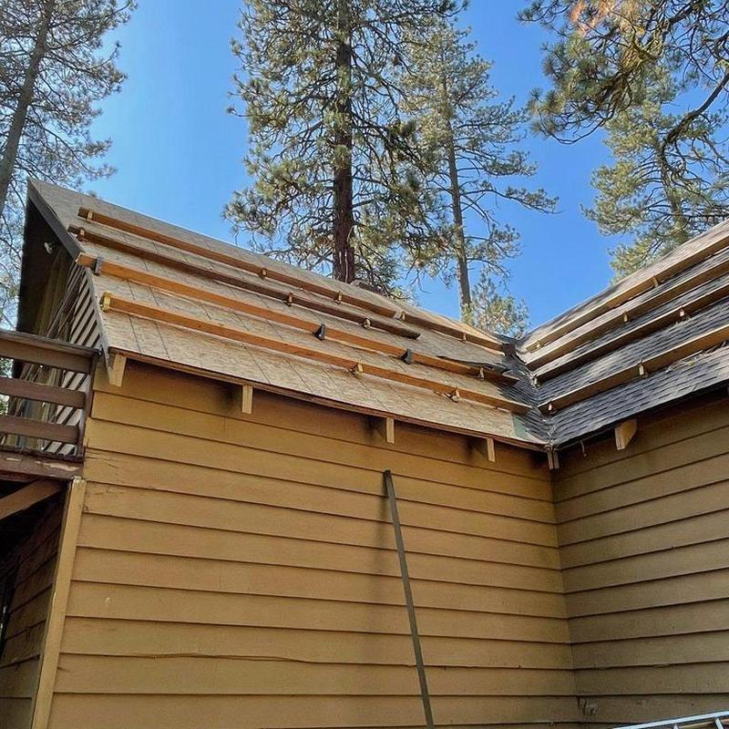 Asphalt roof decking with new plywood installation