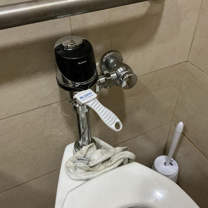 Sloan flush valve installed on commercial toilet Sloan flush valve installed on commercial toilet