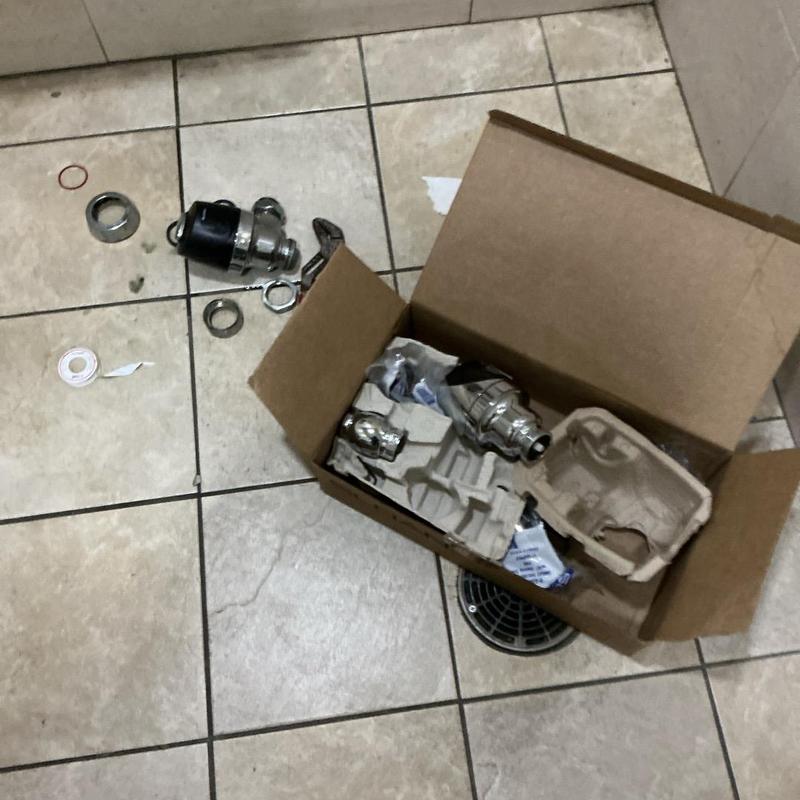 Sloan toilet flush valve parts on bathroom floor tiles Sloan toilet flush valve parts on bathroom floor tiles