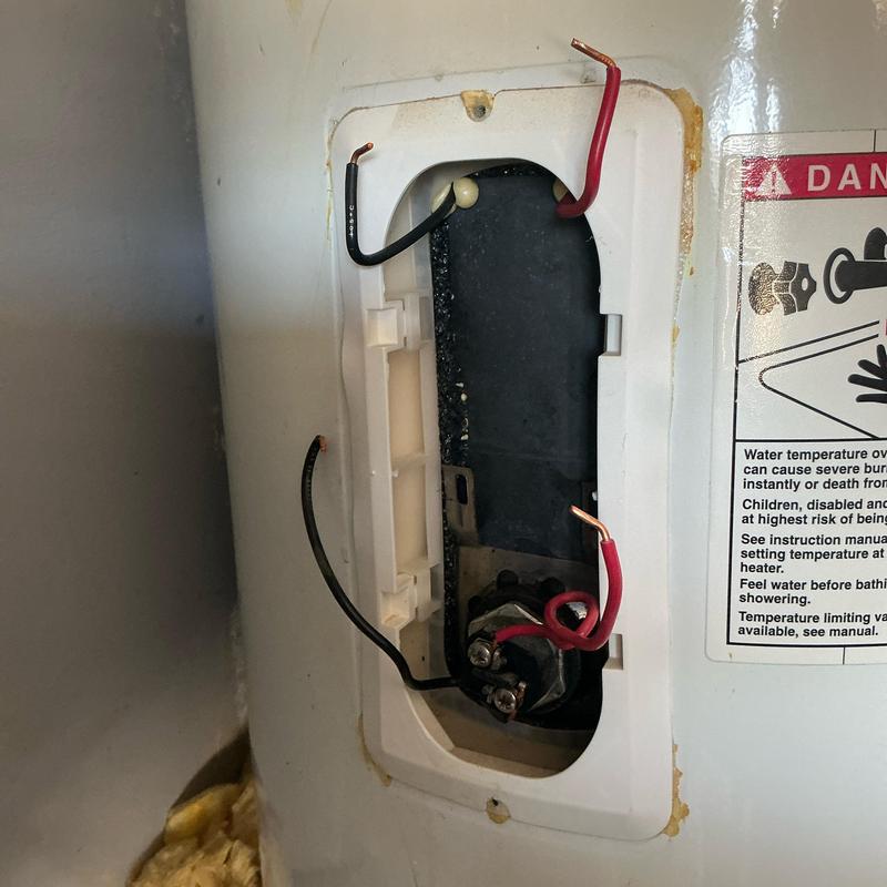Water heater lower heating element and thermostat wires exposed Water heater lower heating element and thermostat wires exposed