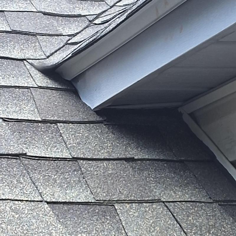 Roof shingles and dormer flashing close-up with cables Roof shingles and dormer flashing close-up with cables