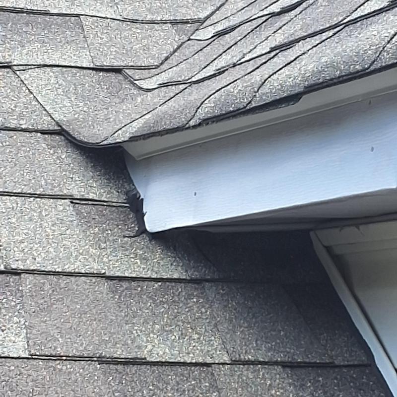 Dormer roofing shingles with edge damage and gaps Dormer roofing shingles with edge damage and gaps