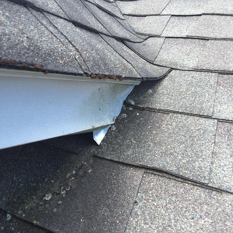 Roof shingles and flashing with debris and wear Roof shingles and flashing with debris and wear