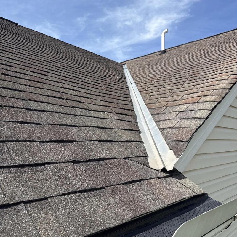 Asphalt shingle roof with metal valley flashing