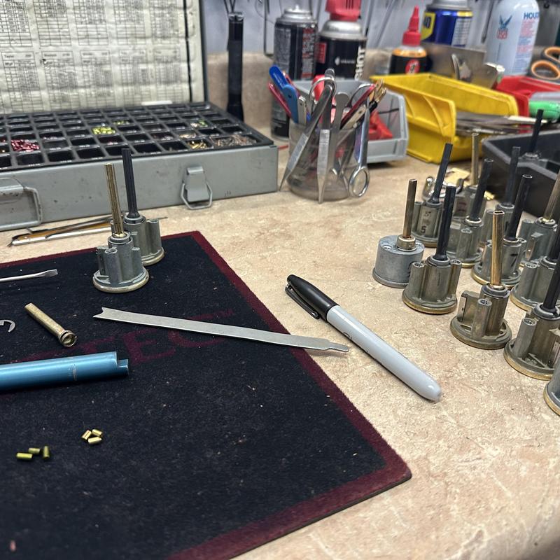 Lock cylinder rekeying setup with tools on workbench Lock cylinder rekeying setup with tools on workbench