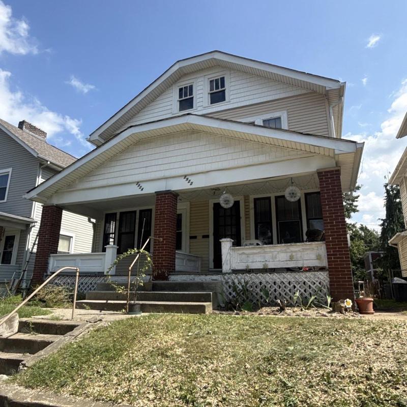 Residential duplex roof with porch and brick columns