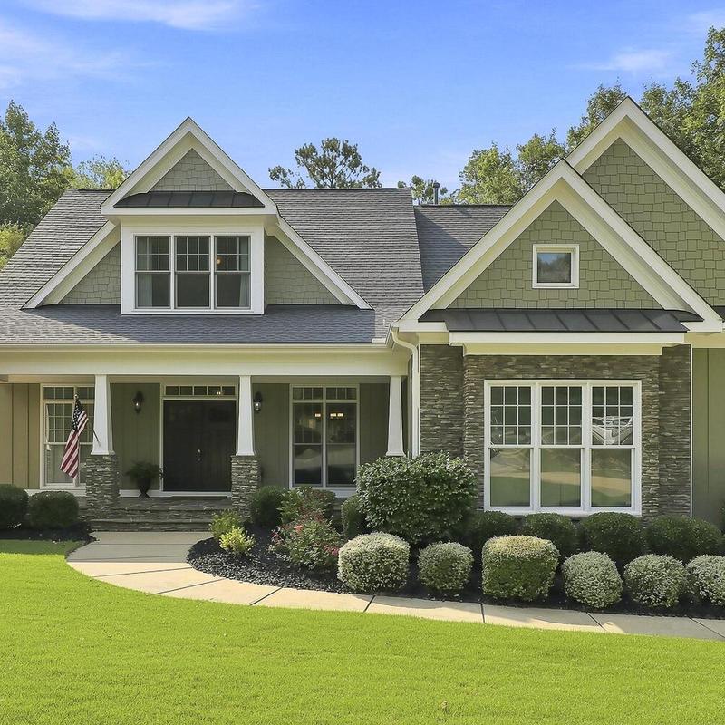 Front yard landscaping with shrubs and walkway