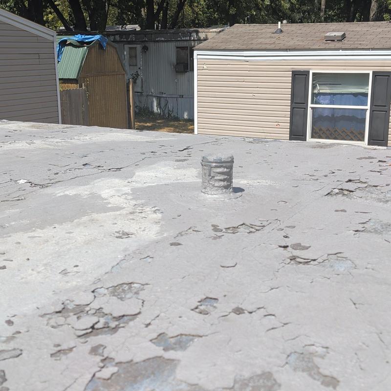 Metal mobile home roof with peeling coating and vent pipe
