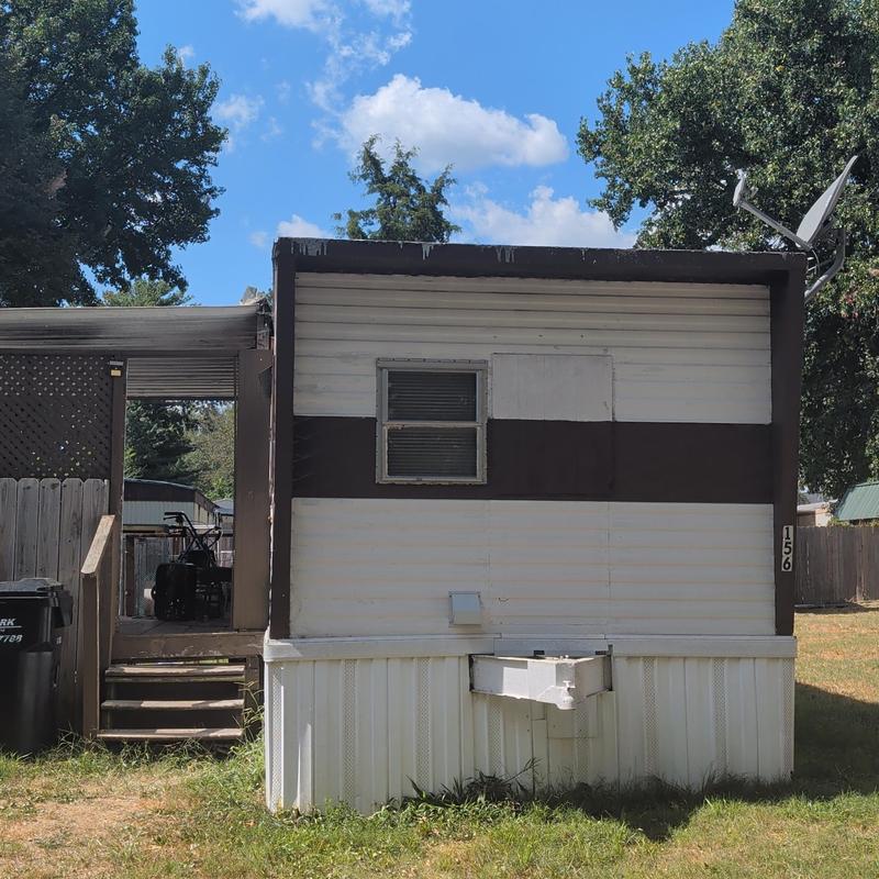 Metal mobile home roof with hail damage craters