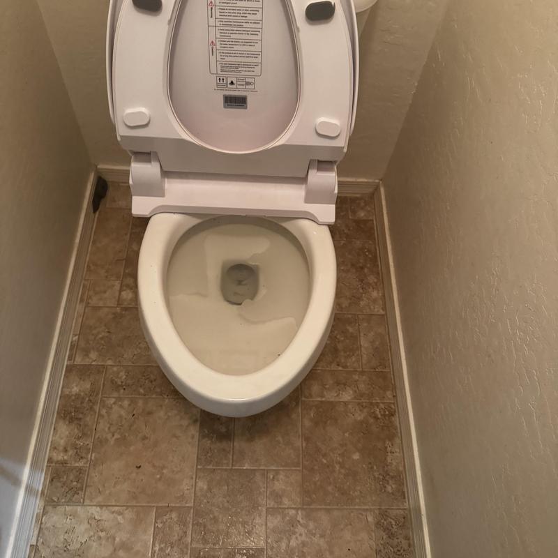 Master bathroom toilet with open lid on tiled floor Master bathroom toilet with open lid on tiled floor