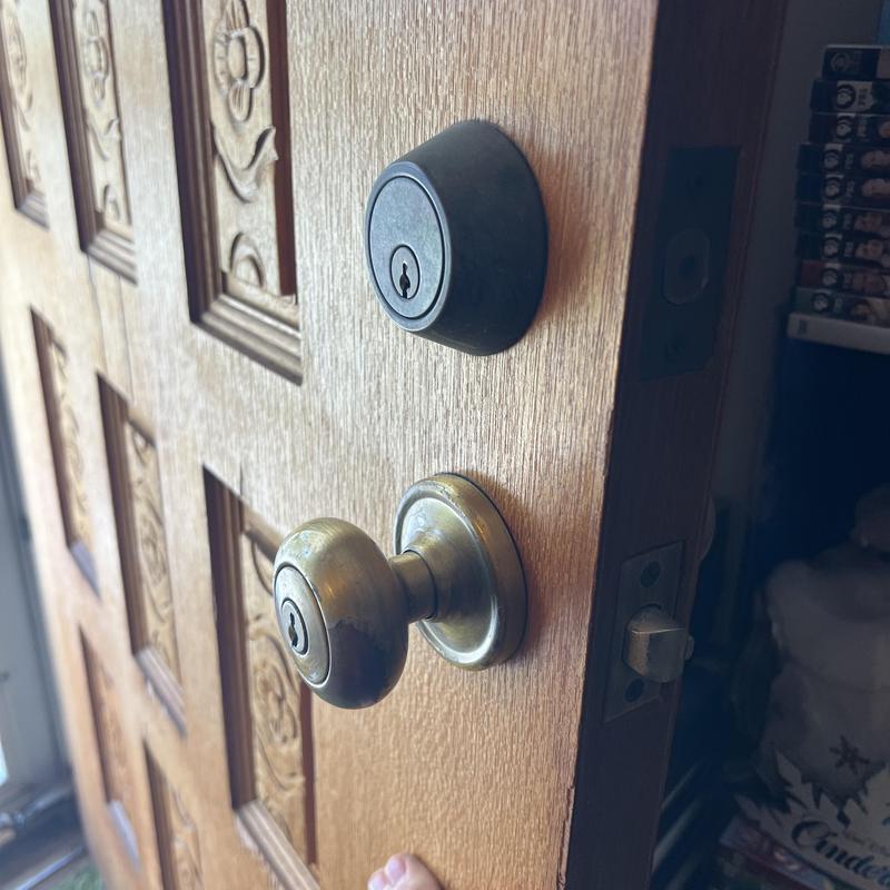 Front door knob and deadbolt lock rekeying in progress Front door knob and deadbolt lock rekeying in progress