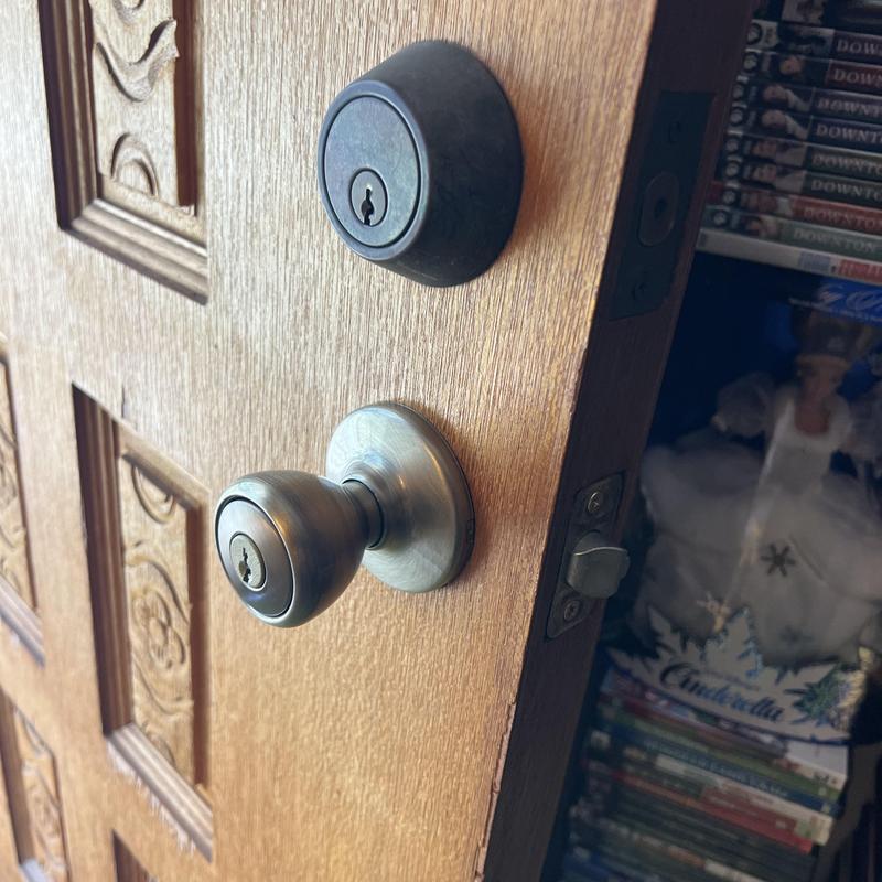 Door knob and deadbolt lock on wooden door Door knob and deadbolt lock on wooden door