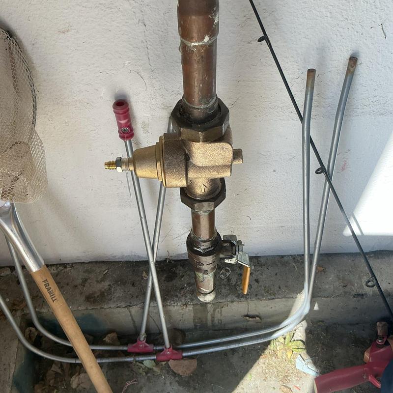 Pressure regulator valve with copper piping outdoors Pressure regulator valve with copper piping outdoors
