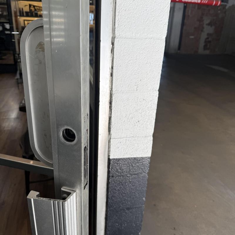 Storefront door lock rekey in barbershop entrance Storefront door lock rekey in barbershop entrance