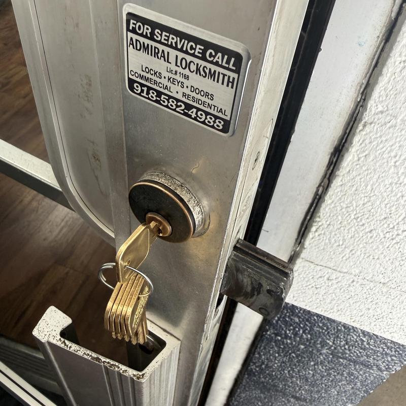 Storefront door lock with new keys on metal door Storefront door lock with new keys on metal door