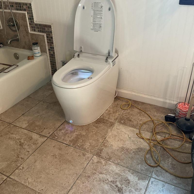 Smart bidet toilet with open lid in bathroom Smart bidet toilet with open lid in bathroom