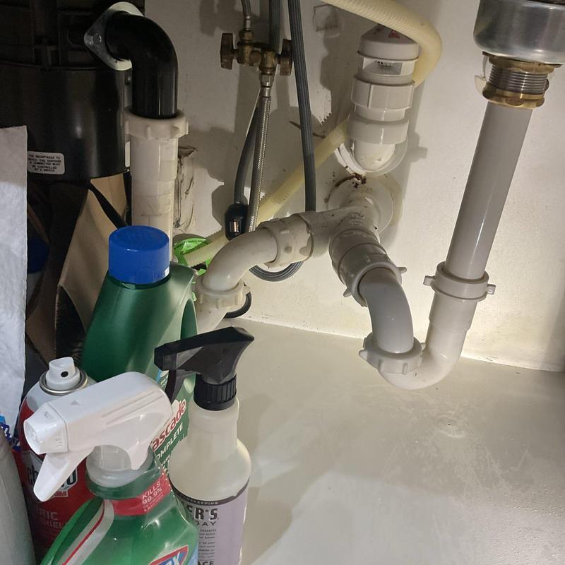 Kitchen sink basket strainer and drain pipes under cabinet Kitchen sink basket strainer and drain pipes under cabinet