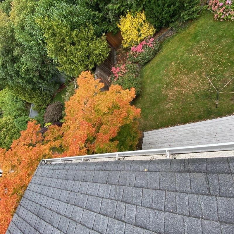 Gutter system on roof edge with fall foliage
