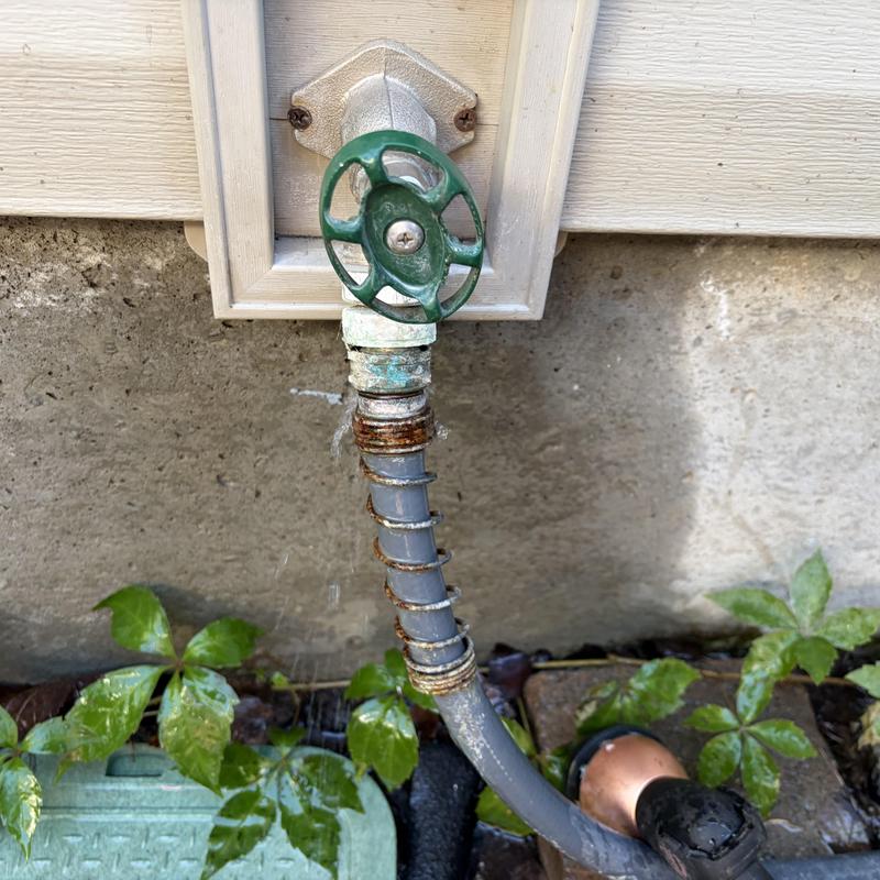 Outdoor hose bib with old connected garden hose Outdoor hose bib with old connected garden hose