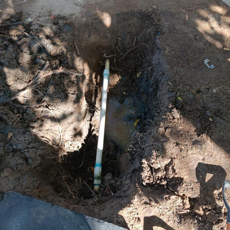 Water main pipe exposed in trench for repair Water main pipe exposed in trench for repair