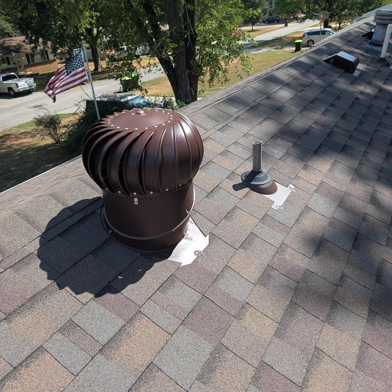 Roof ventilation turbine and shingles on asphalt roof