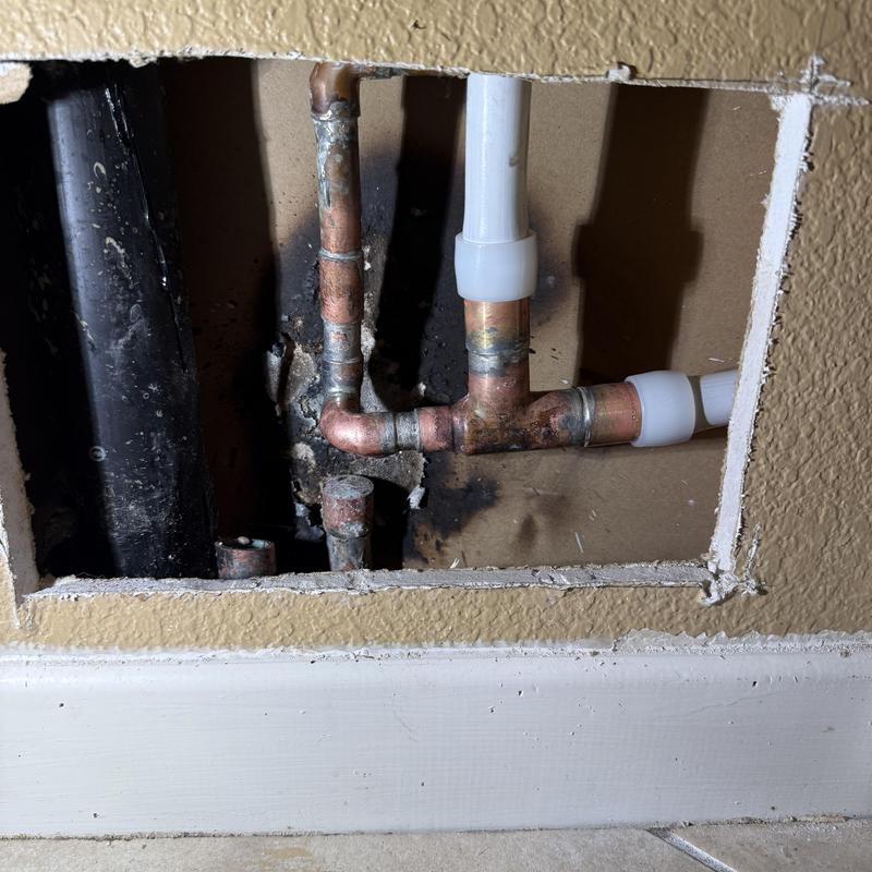 Copper and PEX plumbing pipes with soldered joints in wall cavity Copper and PEX plumbing pipes with soldered joints in wall cavity