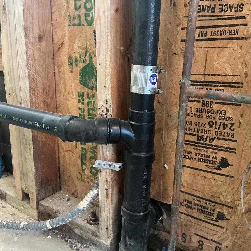 ABS drain piping installation with pipe clamp in wall cavity ABS drain piping installation with pipe clamp in wall cavity