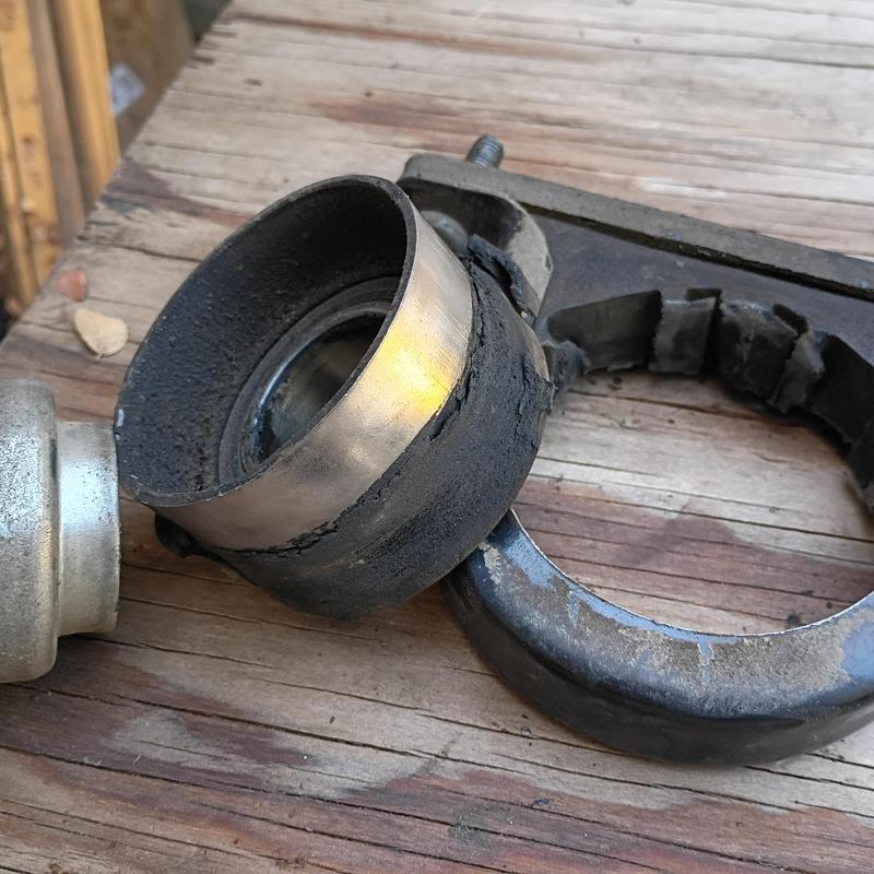 Carrier bearing and mount with worn rubber on wood surface Carrier bearing and mount with worn rubber on wood surface