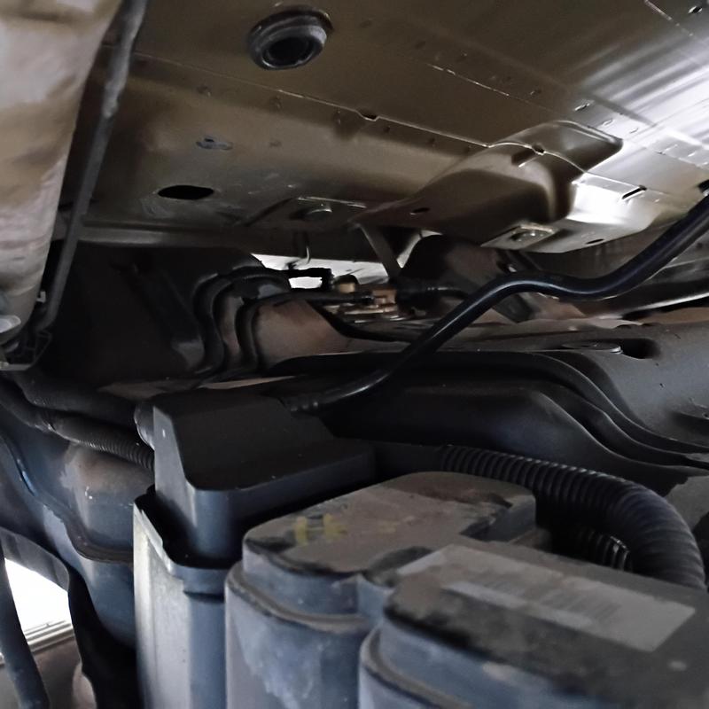 Fuel pump replacement under car chassis at apartment complex Fuel pump replacement under car chassis at apartment complex