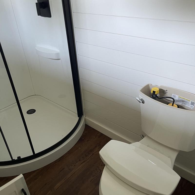 Toilet tank with internal components exposed in bathroom Toilet tank with internal components exposed in bathroom
