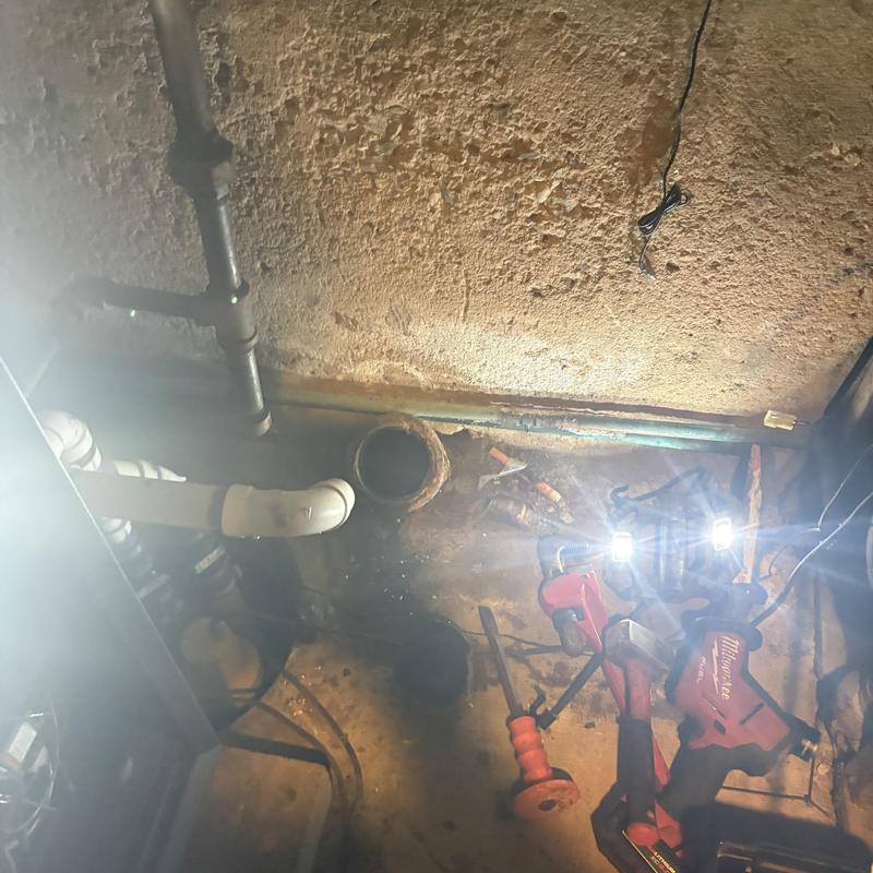 Main line pipe and tools in basement repair site Main line pipe and tools in basement repair site