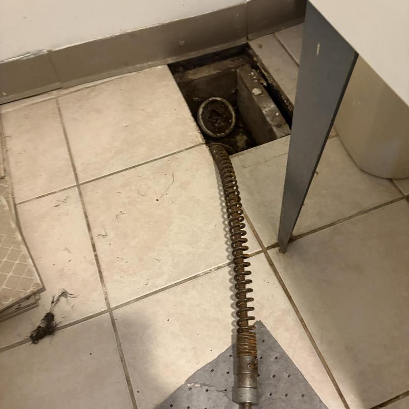 Floor drain with sewer jetting cable in bathroom floor tile Floor drain with sewer jetting cable in bathroom floor tile