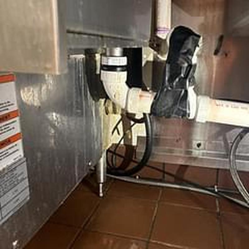 Drain piping under commercial sink with support braces