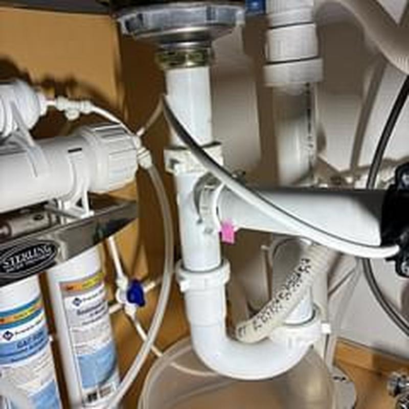 Basket strainer and tailpiece plumbing under sink