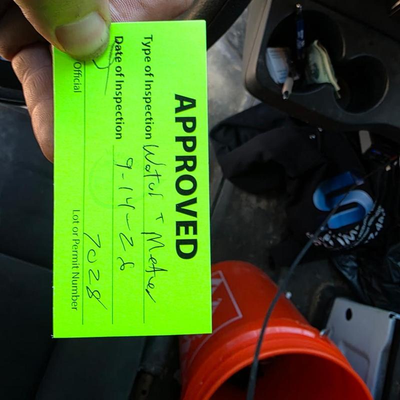 Water meter inspection approval card held in hand Water meter inspection approval card held in hand