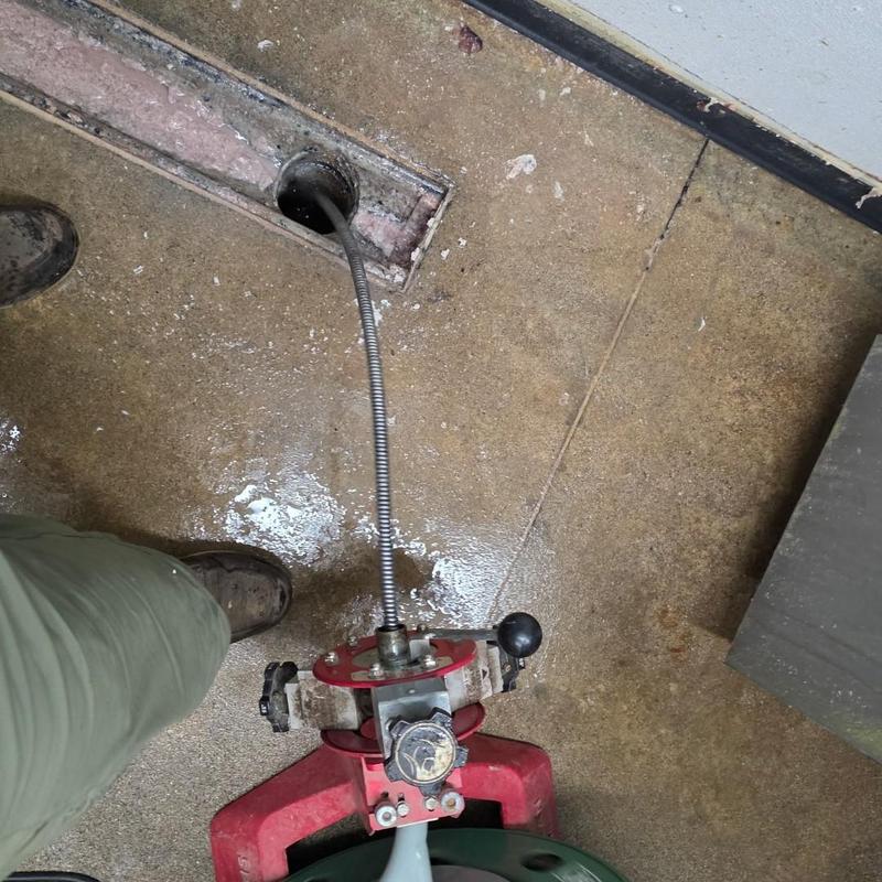 Strip drain cleaning tool in butcher area floor drain Strip drain cleaning tool in butcher area floor drain
