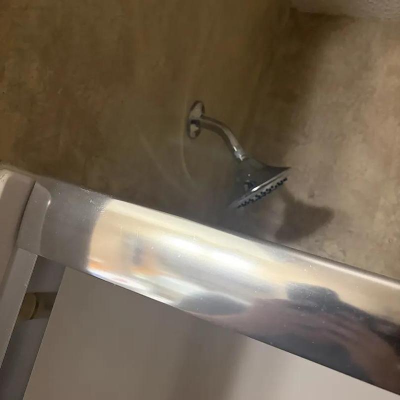 Shower valve and showerhead in tiled shower area