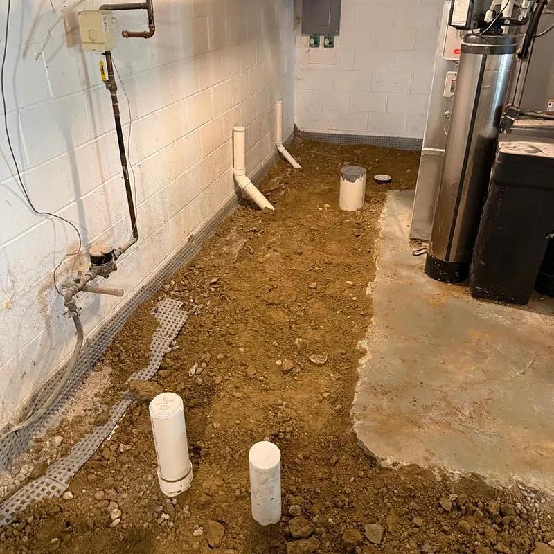 Basement plumbing repiping with exposed pipes and dirt floor