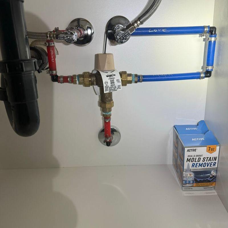 Water heater flush valve with connected piping under sink Water heater flush valve with connected piping under sink