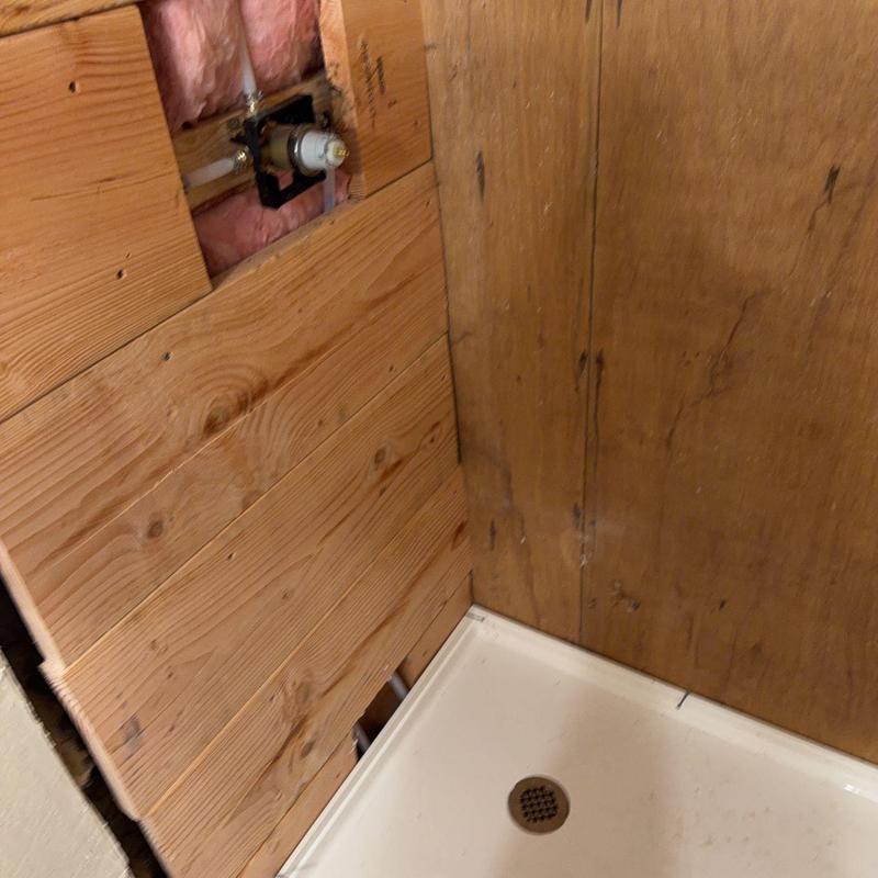 Shower pan installation with adjusted drain and plumbing Shower pan installation with adjusted drain and plumbing