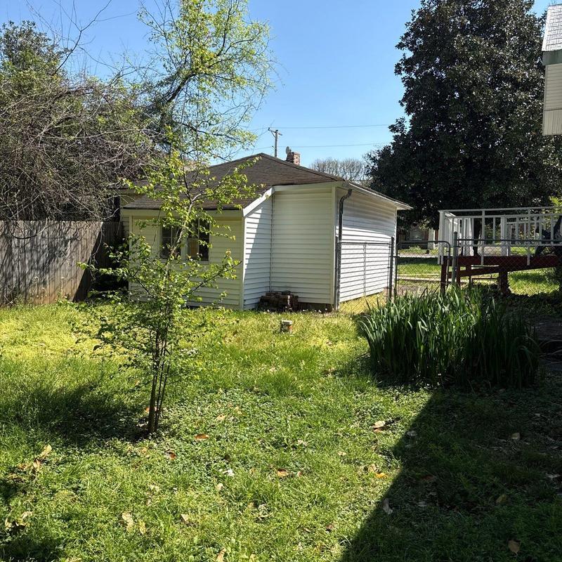 Detached garage siding and gutters with yard view