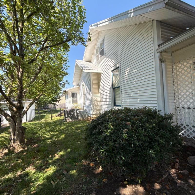 Roof shingles inspection with hail damage visible