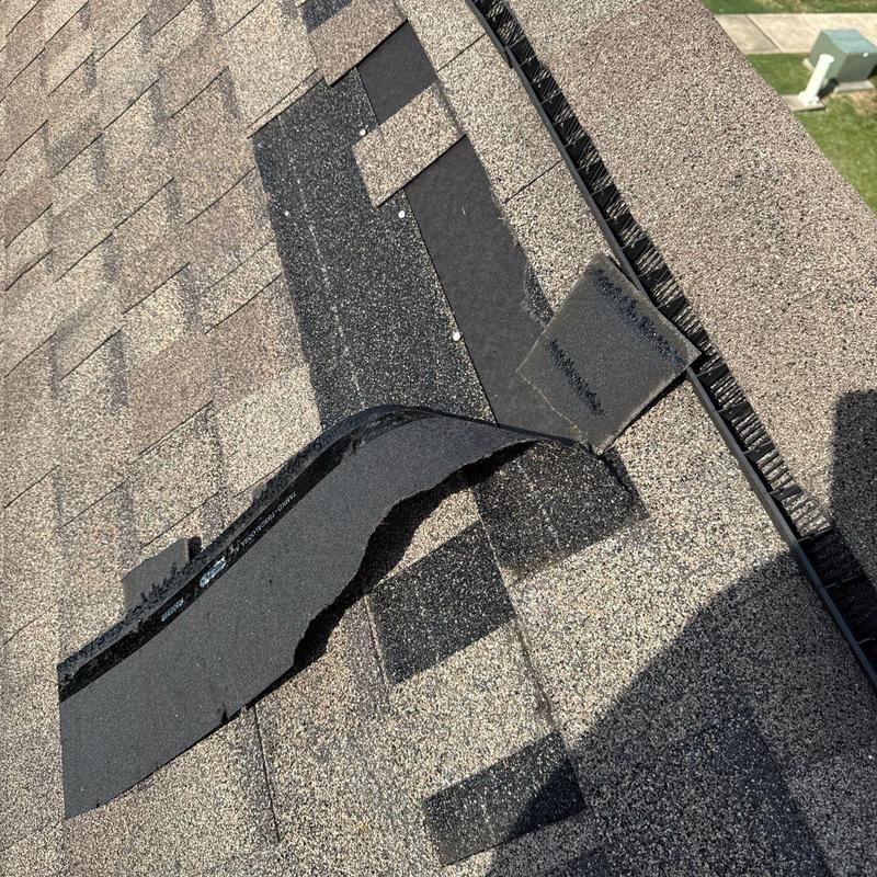 Asphalt shingles with hail damage and lifting