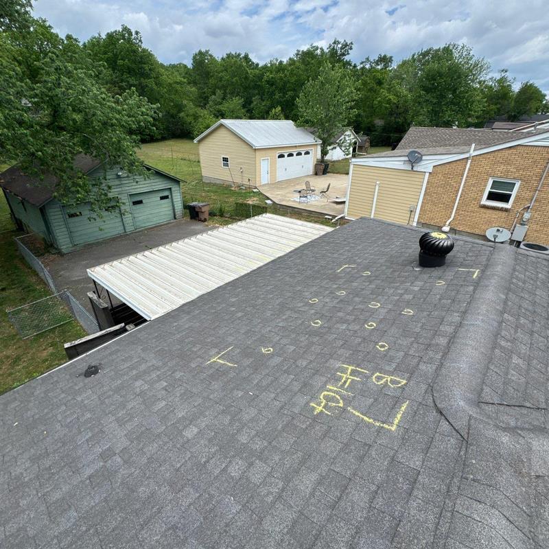 Asphalt shingle roof with hail damage markings
