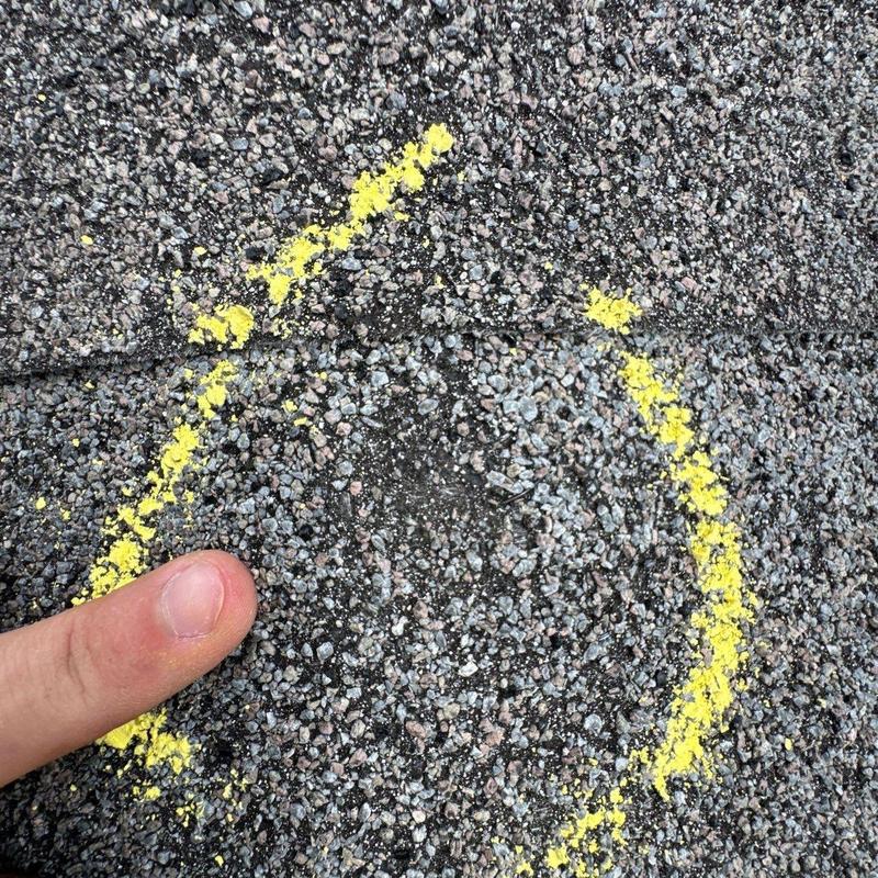 Asphalt shingle roof hail damage marked in yellow