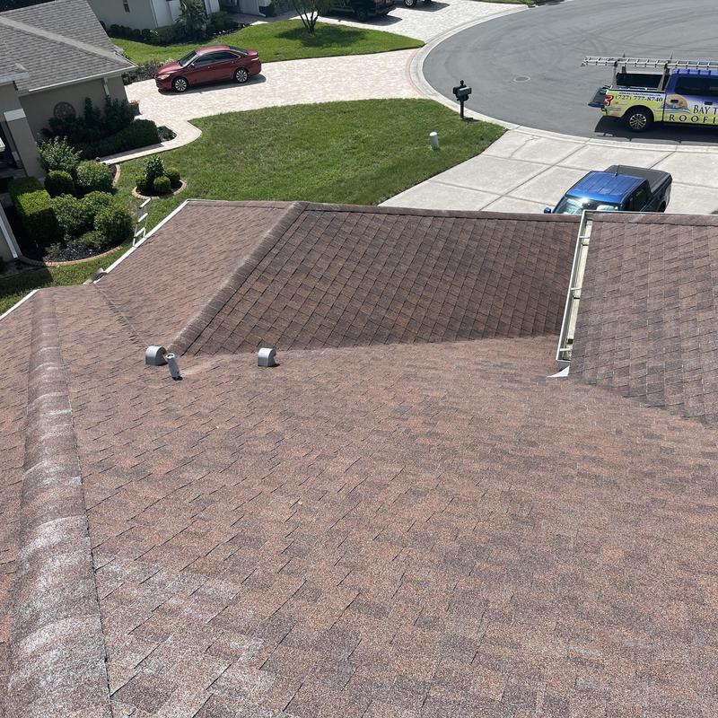 Shingle roof with vent pipes in suburban house cul-de-sac Shingle roof with vent pipes in suburban house cul-de-sac
