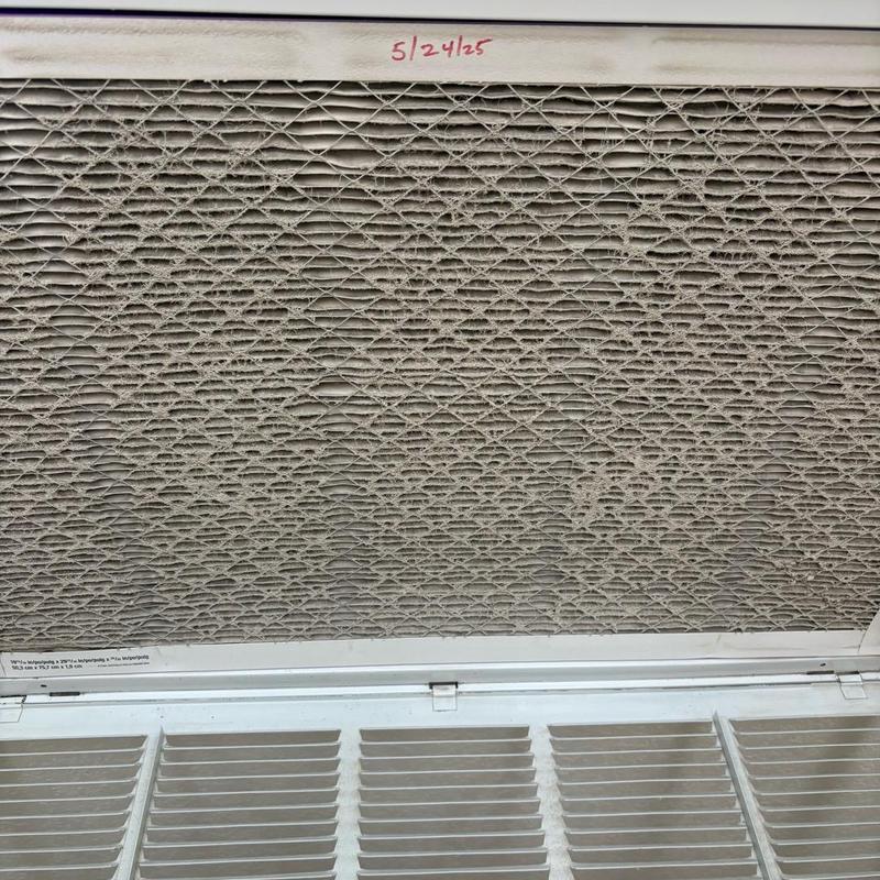 HVAC air filter heavily clogged with dust buildup HVAC air filter heavily clogged with dust buildup